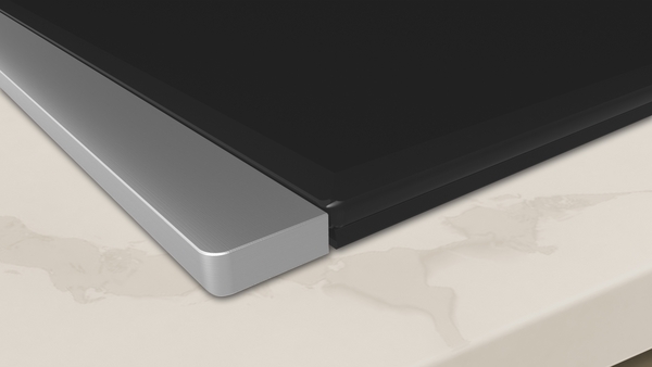 Close-up of a NEFF induction hob installed on a light worktop, showing the smooth glass surface and sleek stainless steel trim – ideal for illustrating what is an induction hob.