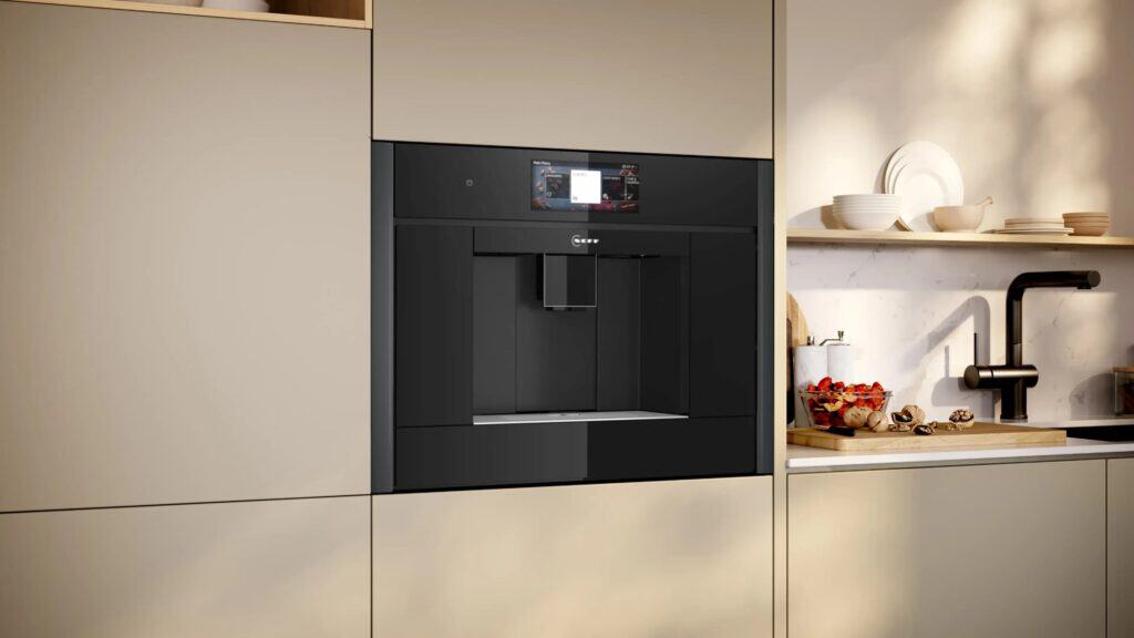 a cream kitchen cabinet with a neff built in coffee machine fitted